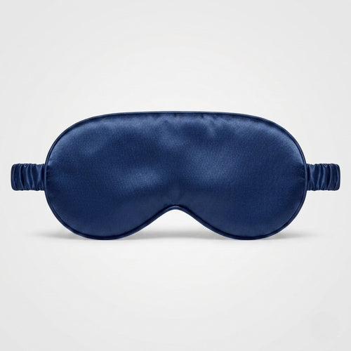 Navy blue silk sleep mask on a light gray background