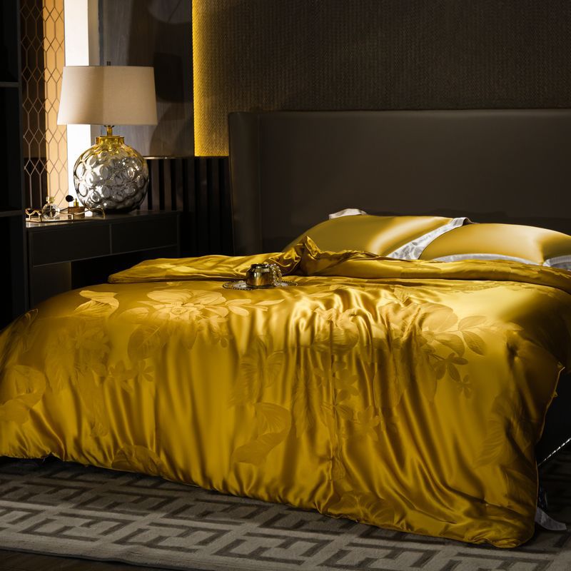 Bed with yellow silk duvet cover in a bedroom setting