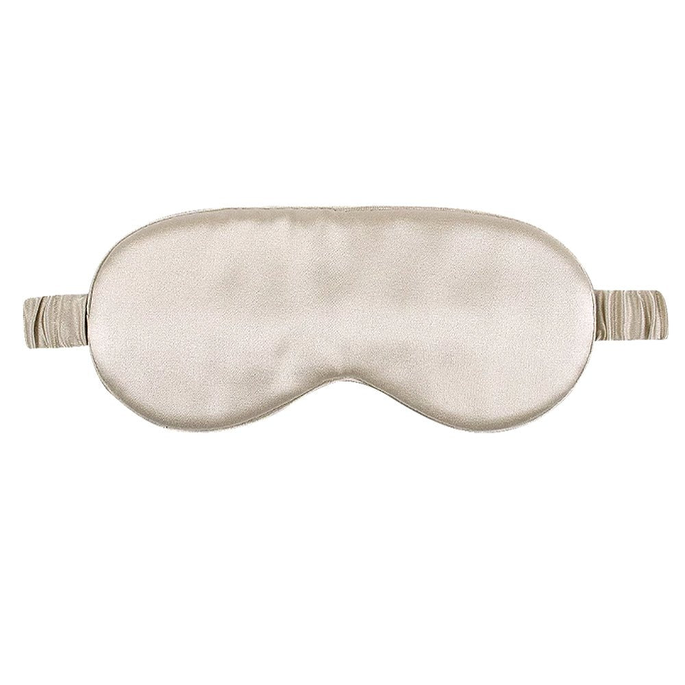 Beige silk sleep mask on a white background