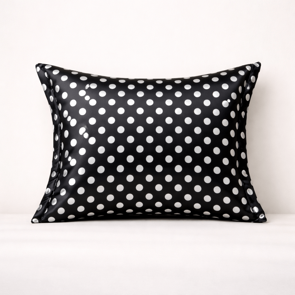 Black pillowcase with white polka dots on a white background