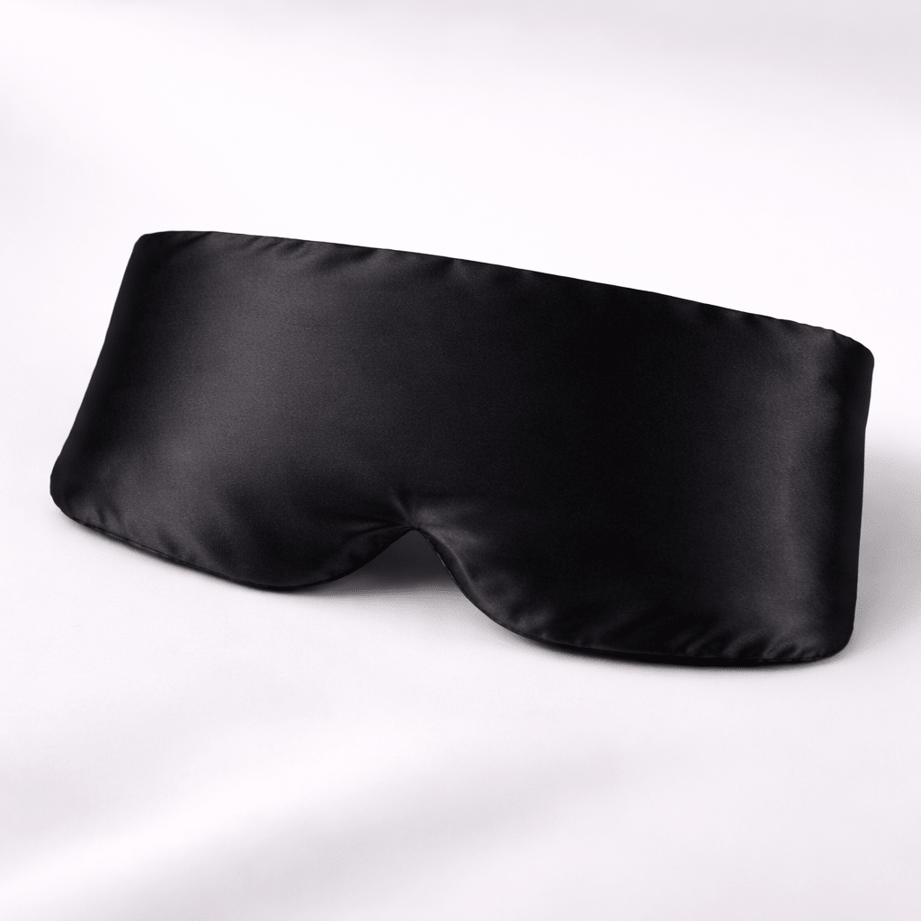 Black silk eye mask on a white background