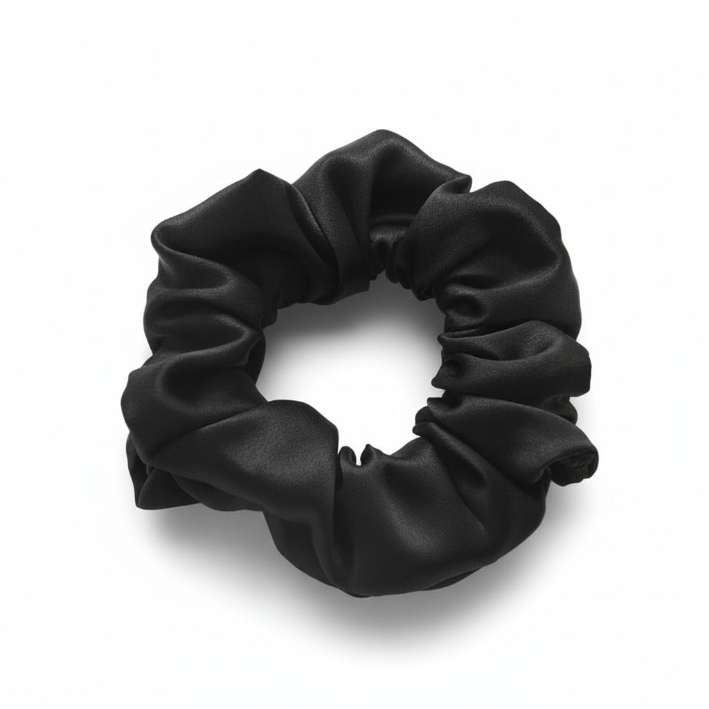 Black silk scrunchie on a white surface