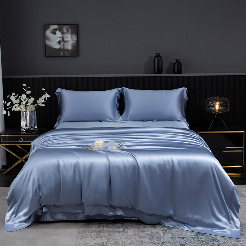 Blue silk bedding set on a bed in a darkly decorated bedroom.