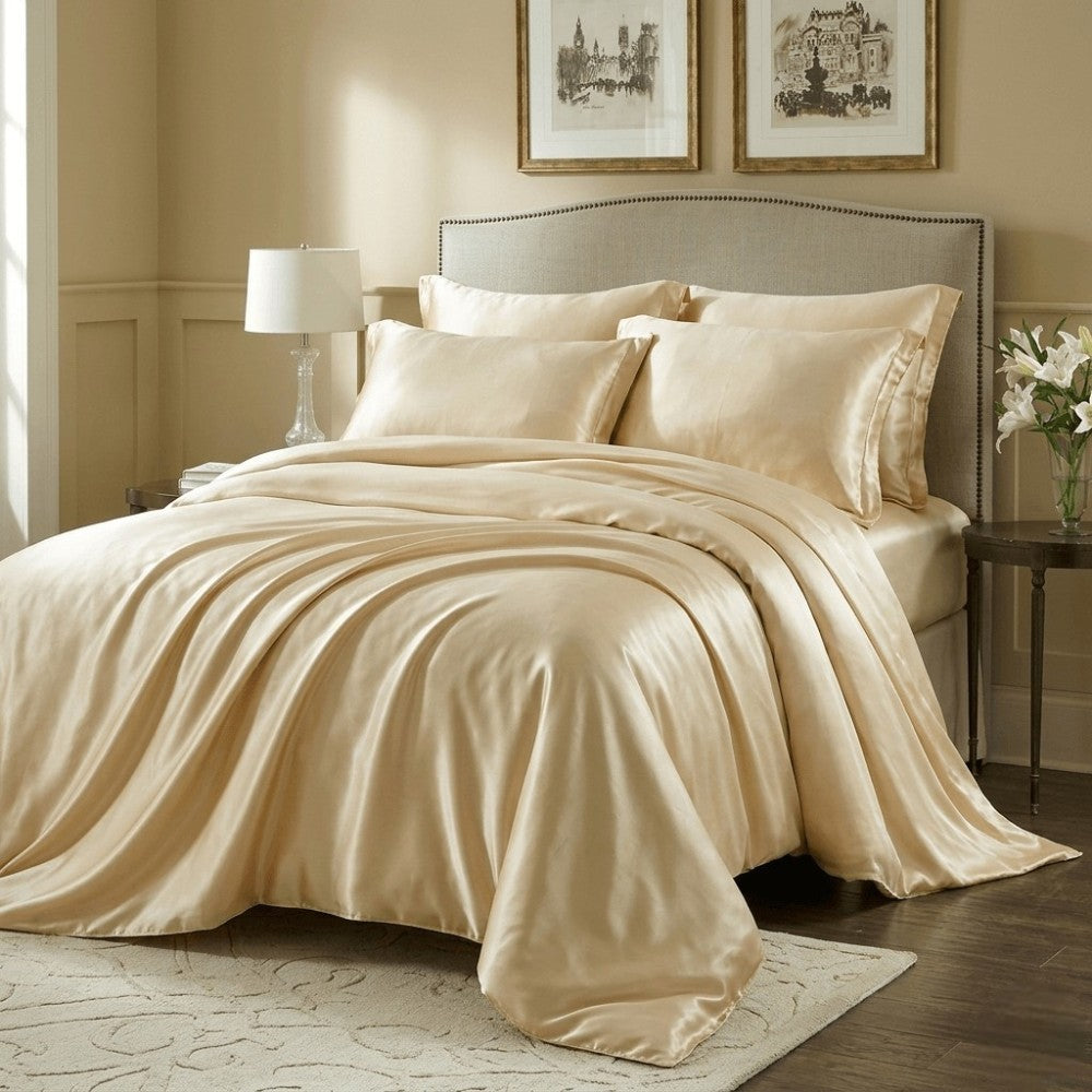 Champagne gold silk duvet cover on a bed in a bedroom with decorative elements.