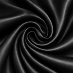 Close-up of black satin fabric with a swirling pattern