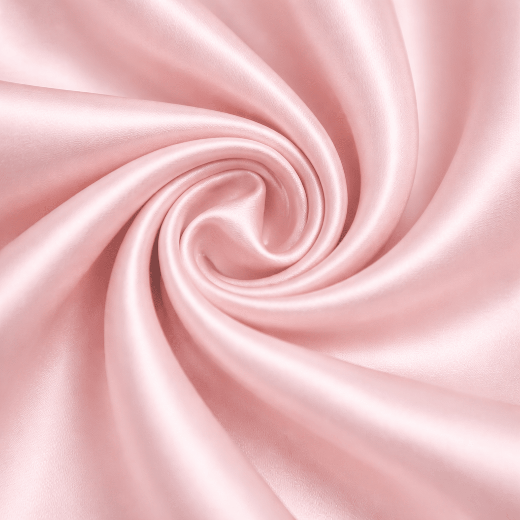 Close-up of pink silk fabric with a swirl pattern