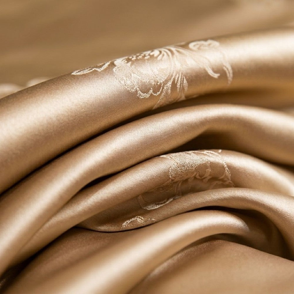 Close-up of champagne gold silk fabric with subtle patterns