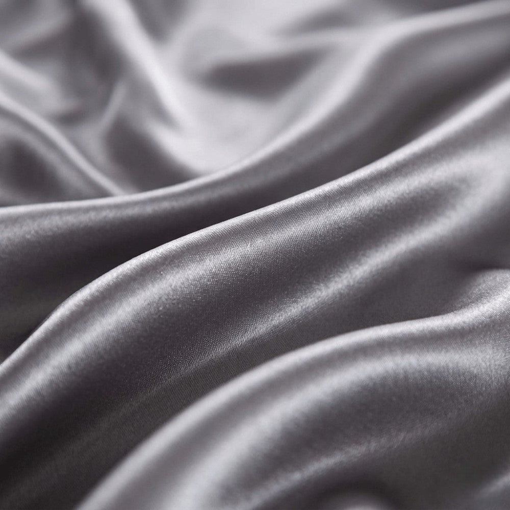 Close-up of gray silk fabric with folds