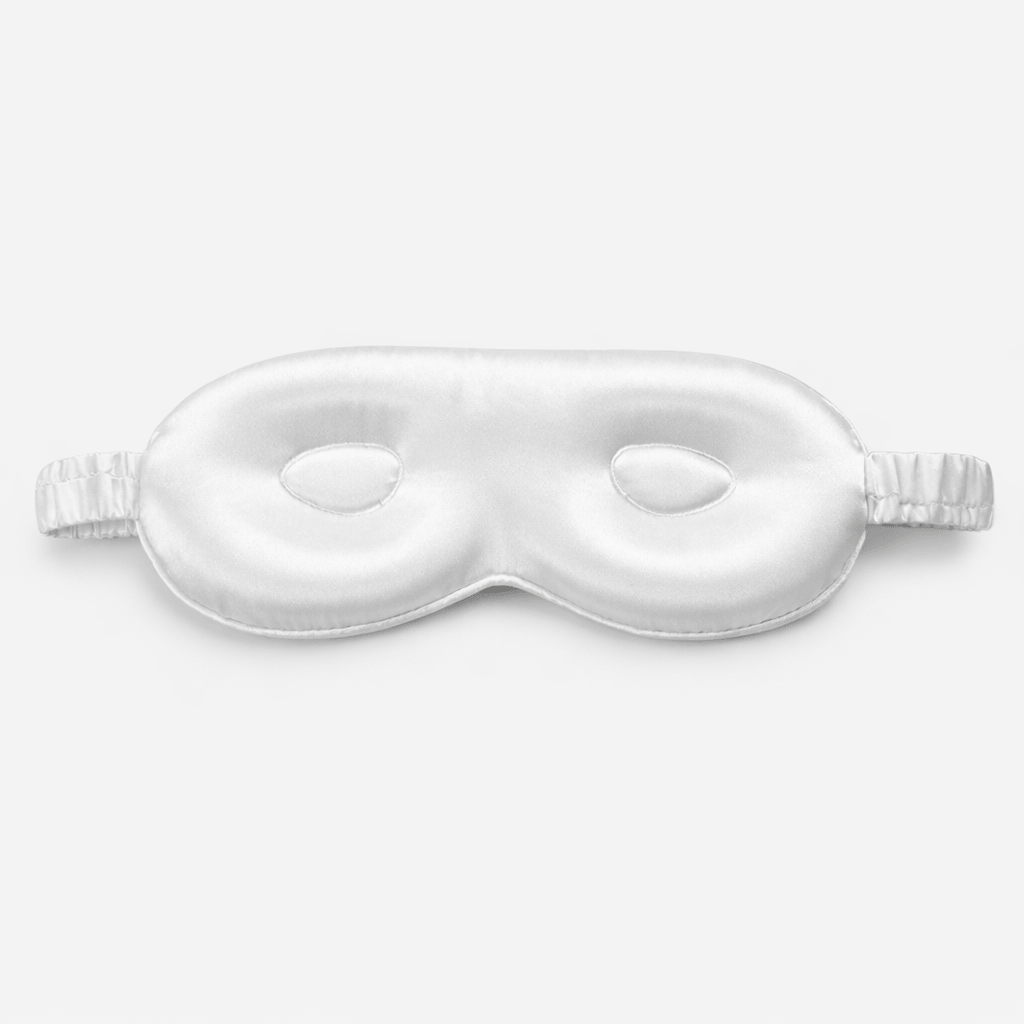 Contoured 3d white sleep mask on a light gray background