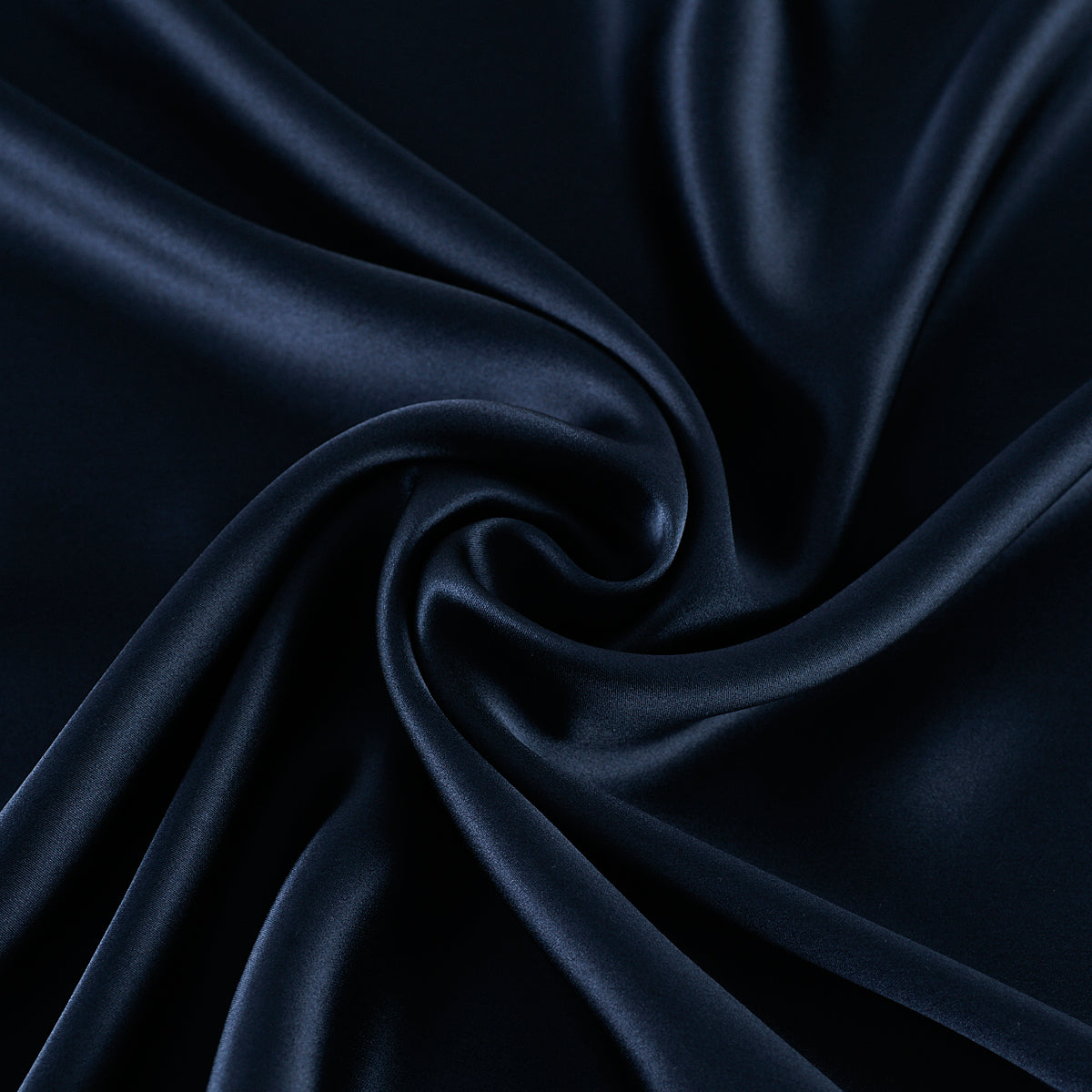 Dark blue sik fabric with folds on a black background