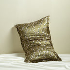 Decorative silk pillowcase with cherry blossom floral pattern on a white surface against a beige background