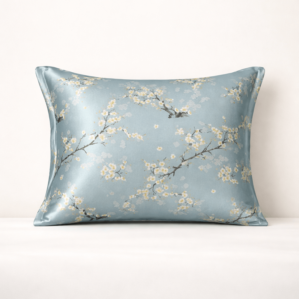 Decorative silk pillowcase with cherry blossom floral pattern on a light blue background