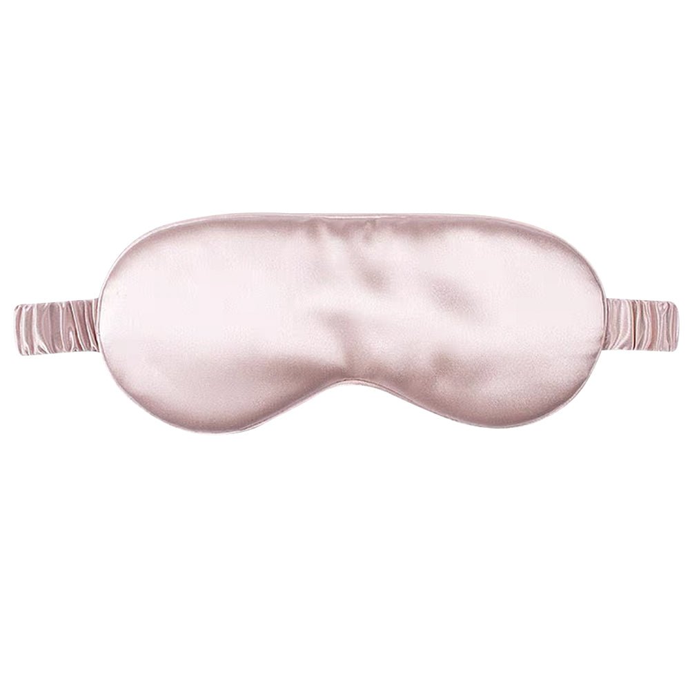Pink silk sleep mask on a white background