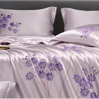 Floral-patterned bedspread with purple flowers on a white background