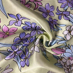 Floral silk fabric with purple and pink flowers on a beige background