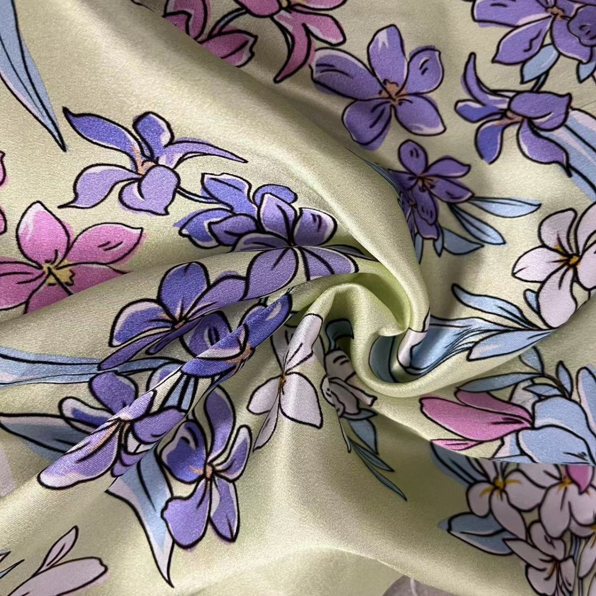 Floral silk fabric with purple and pink flowers on a beige background