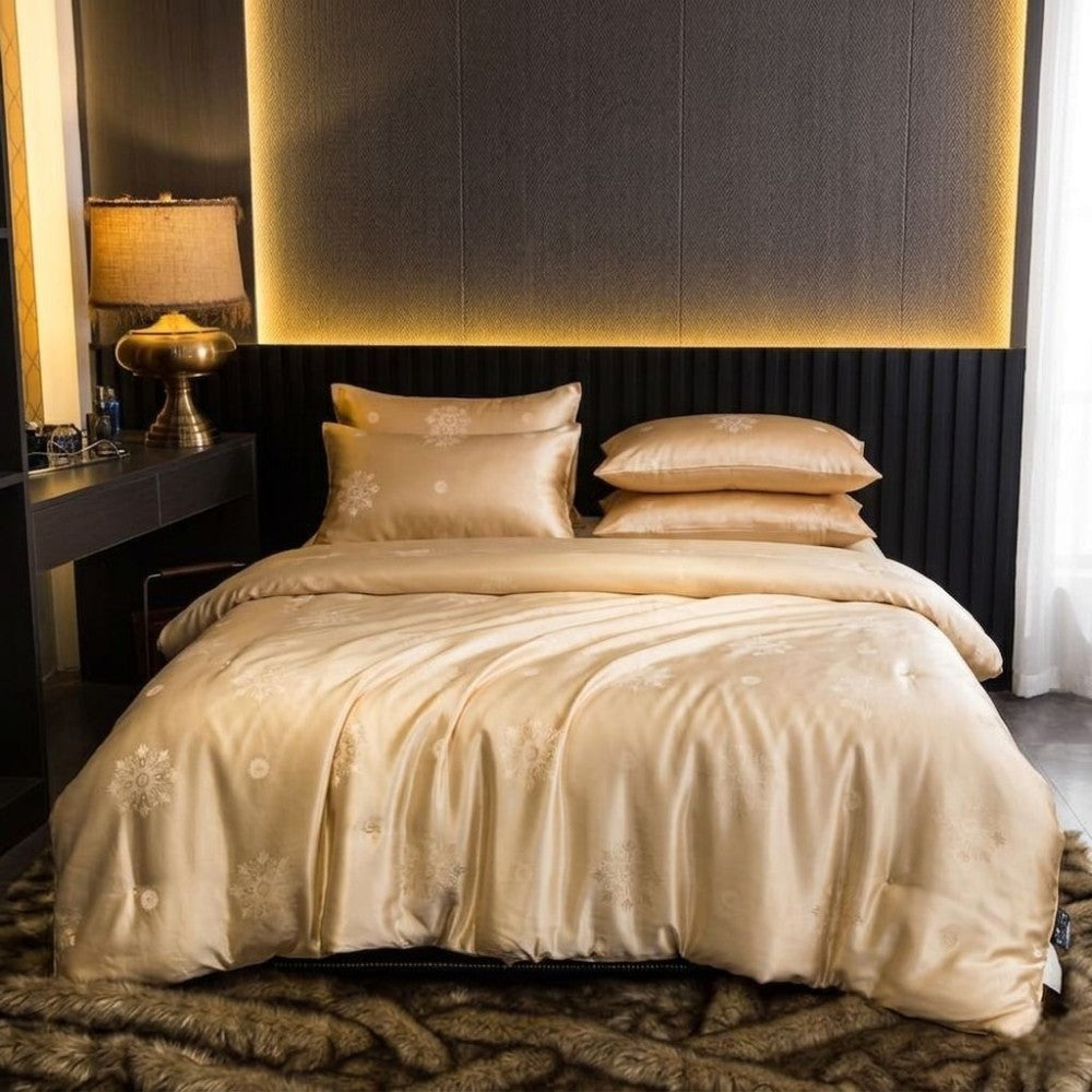 Gold yellow silk duvet cover with decorative pillows on a bed in a bedroom setting.