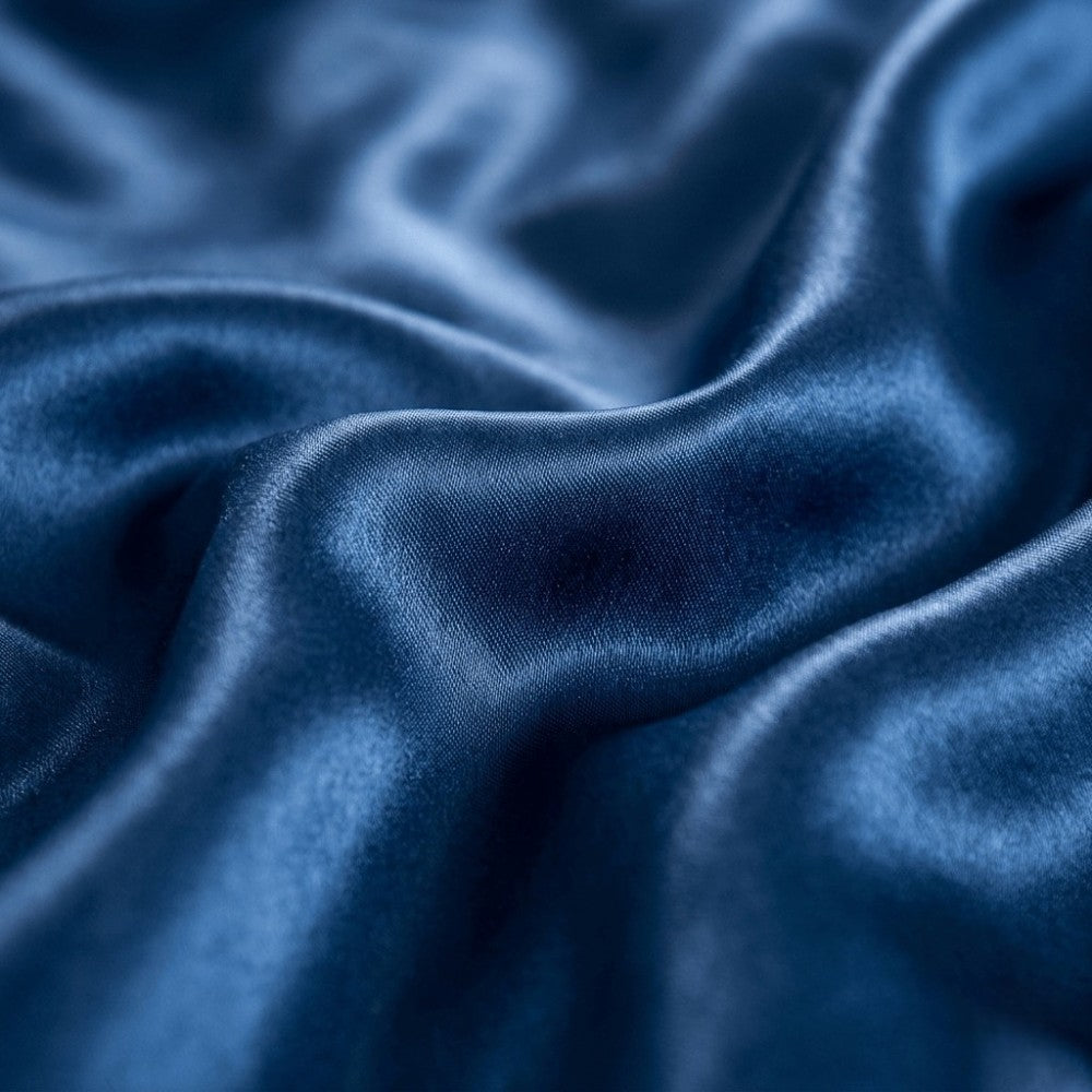 Close-up of navy blue silk fabric with a soft texture