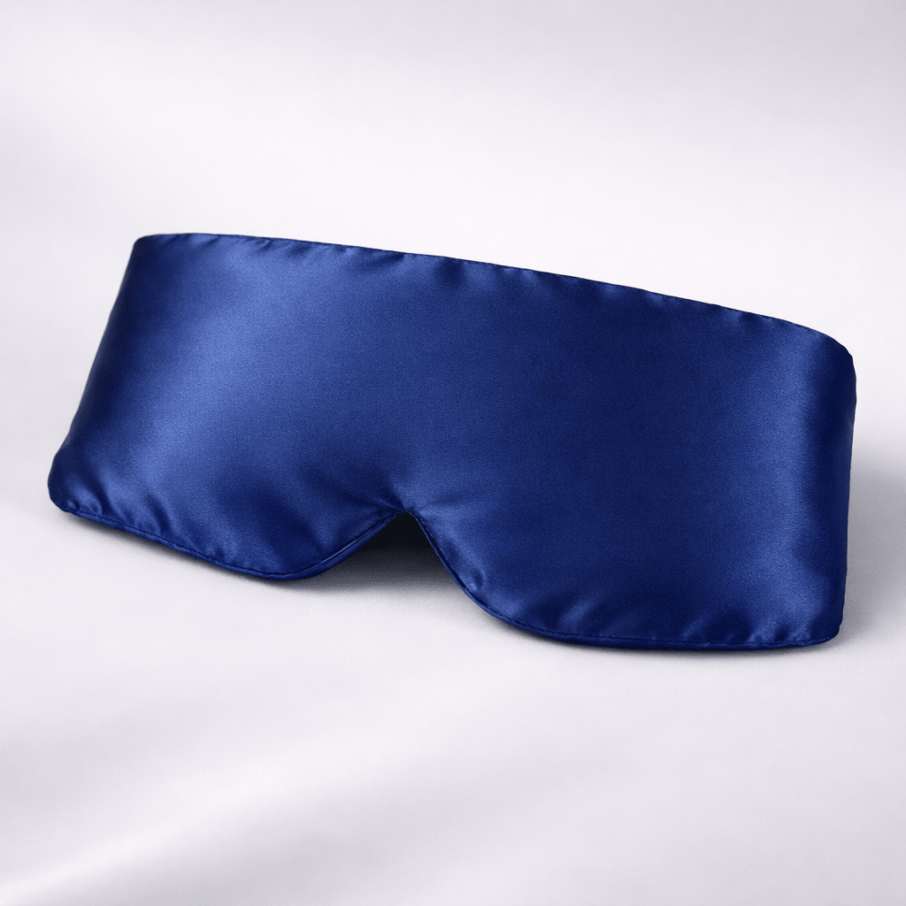 Navy blue silk eye mask on a white background