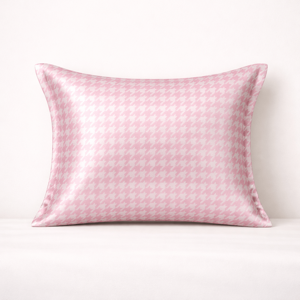 Pink houndstooth silk pillowcase with subtle pattern on a white background