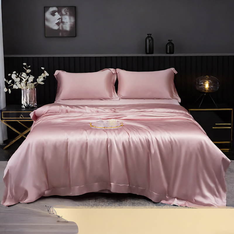 Pink silk bedding set on a bed in a dark-themed bedroom.