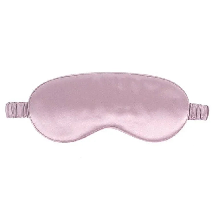Pink silk eye mask on a white background