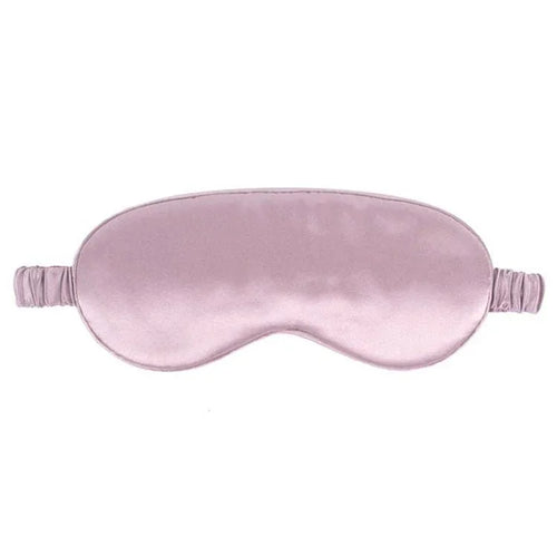 Pink silk eye mask on a white background