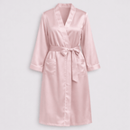 Pink silk robe on a light gray background