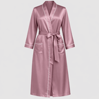 Pink silk robe with white trim on a light gray background