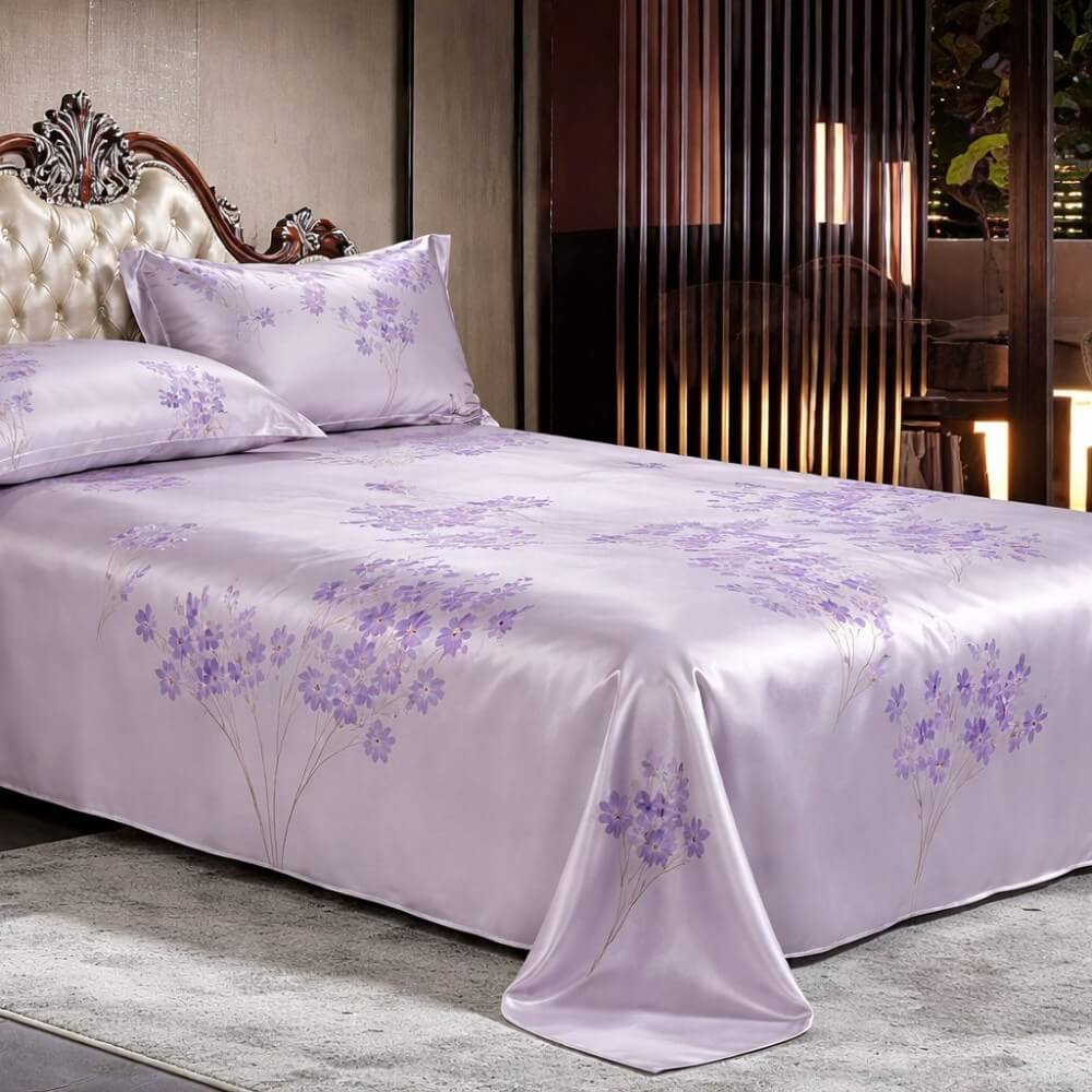 Purple silk floral bedspread on a bed in a bedroom setting