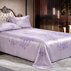 Purple silk floral bedspread on a bed in a bedroom setting