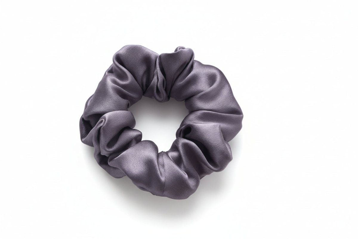 Purple silk scrunchie on a white background