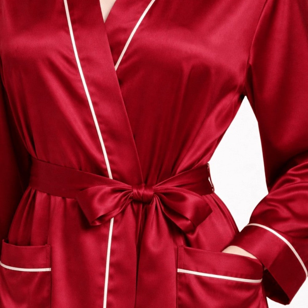 Red silk robe with white piping on a white background