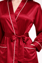 Red silk robe with white piping on a white background