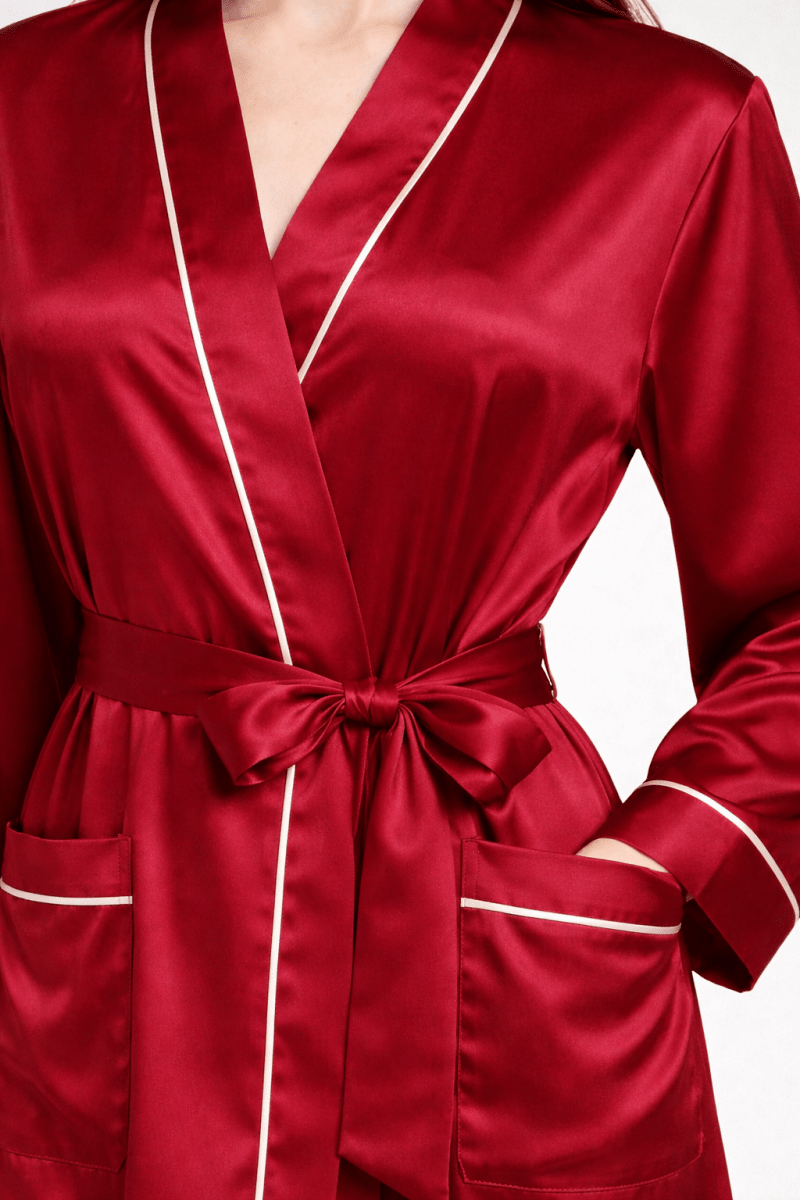 Red silk robe with white piping on a white background