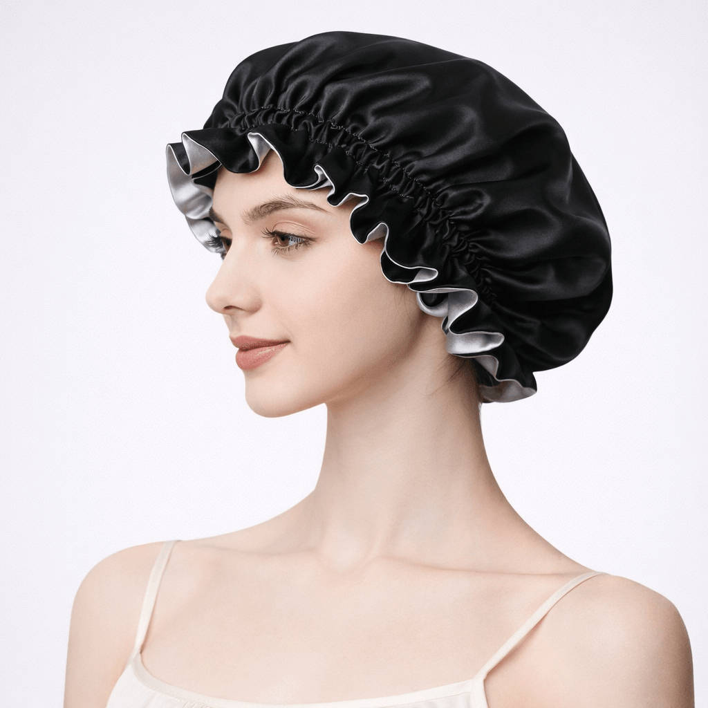 Side view of a woman wearing a black silk bonnet on a white background