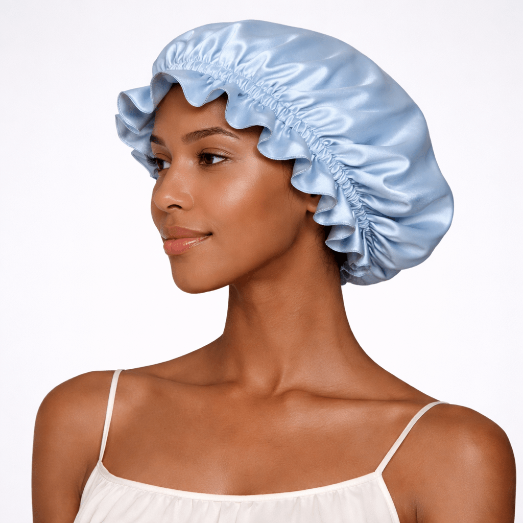 Side view of a woman wearing a blue silk bonnet on a white background