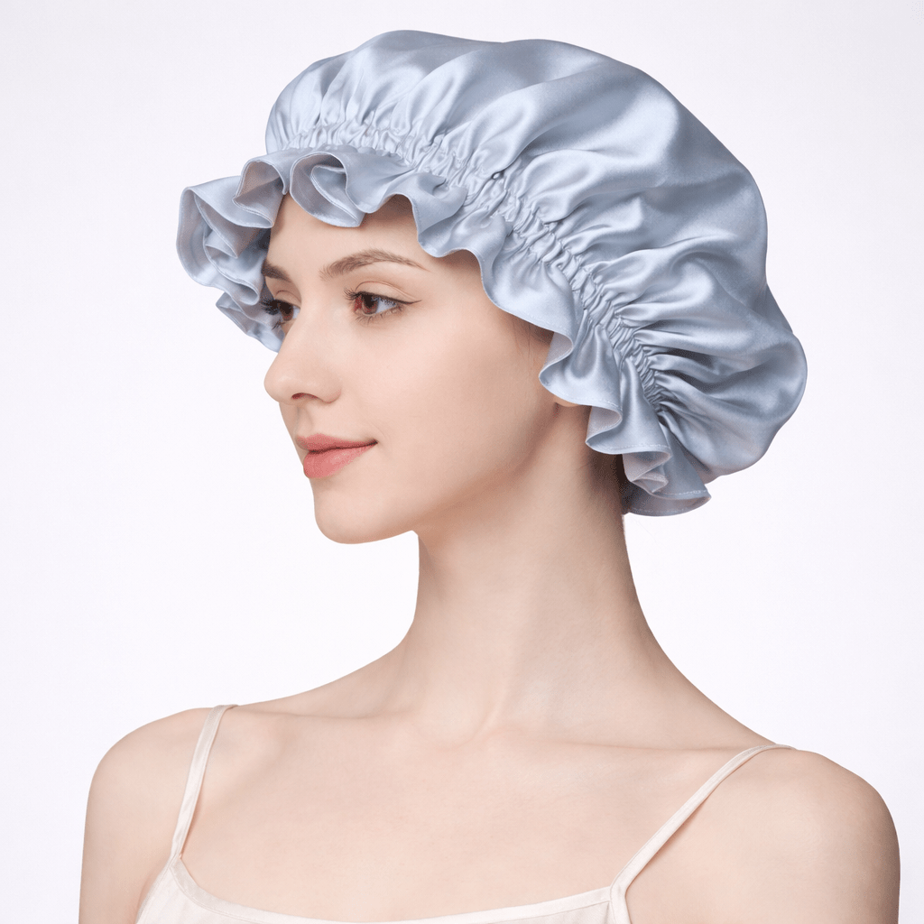 Side view of a woman wearing a light blue silk bonnet on a plain backgroundu