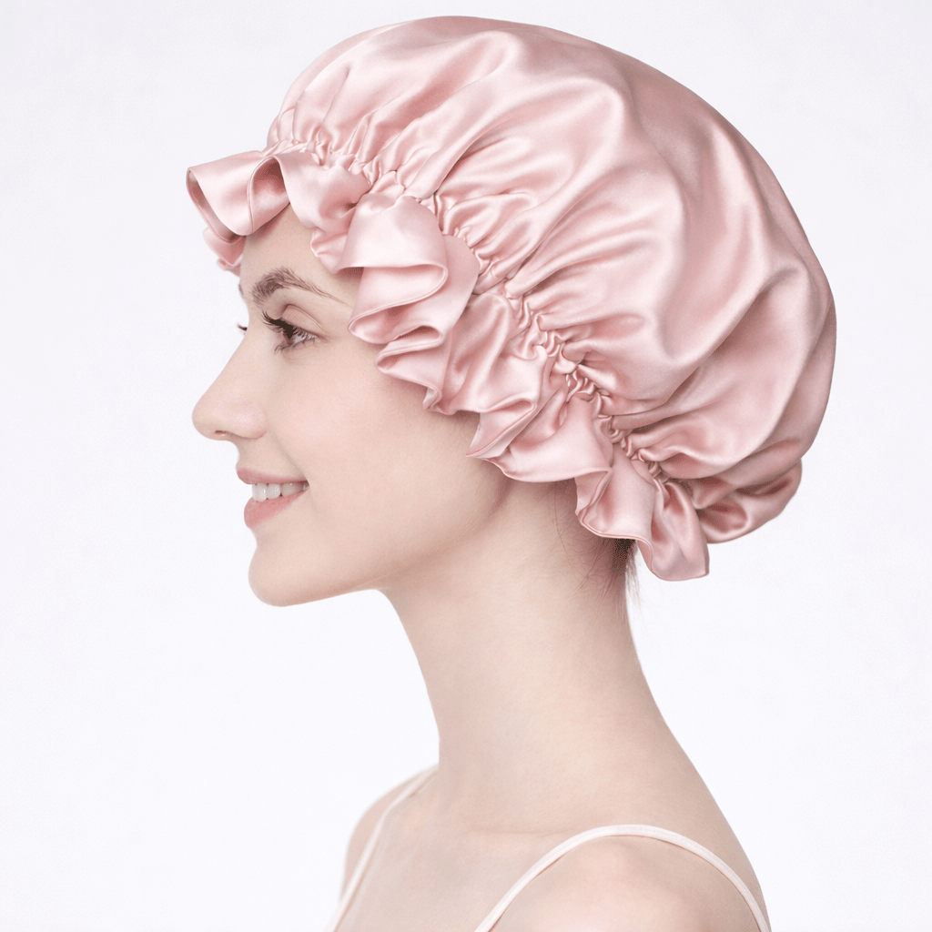 Side view of woman wearing a pink silk bonnet on a white background