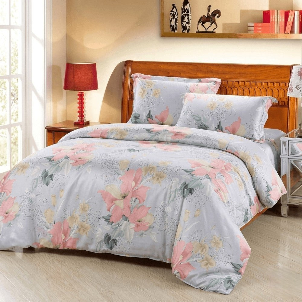 Floral bedding set on a bed in a bedroom with a lamp and books in the background.