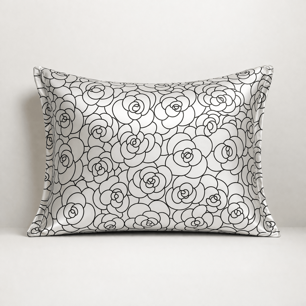 Silk pillowcase with black rose petal floral pattern on a white background