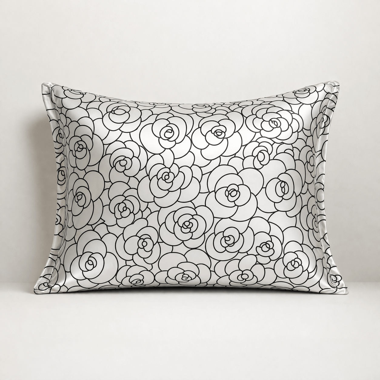 Silk pillowcase with black rose petal floral pattern on a white background