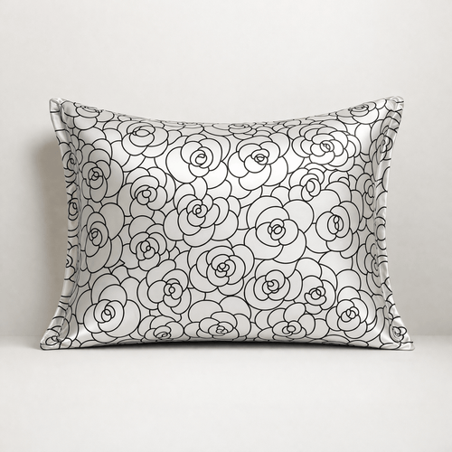 Silk pillowcase with black rose petal floral pattern on a white background