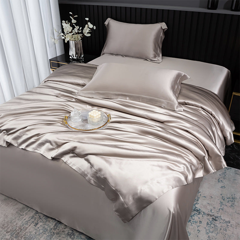 Silky bedding set on a bed with decorative elements.