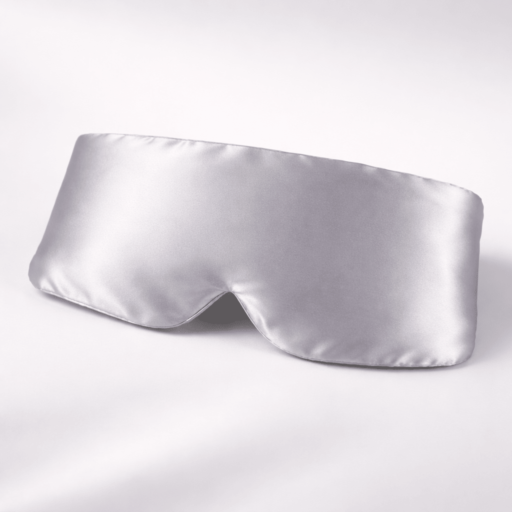 Silky silver sleep mask on a white background