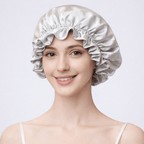 Woman wearing a champagne gold silk bonnet on a plain background