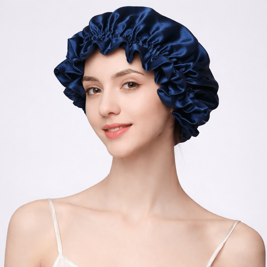 Woman wearing a navy blue silk bonnet on a white background