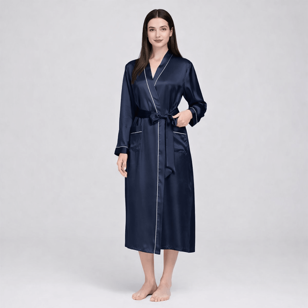 Woman wearing a navy blue silk robe on a white background