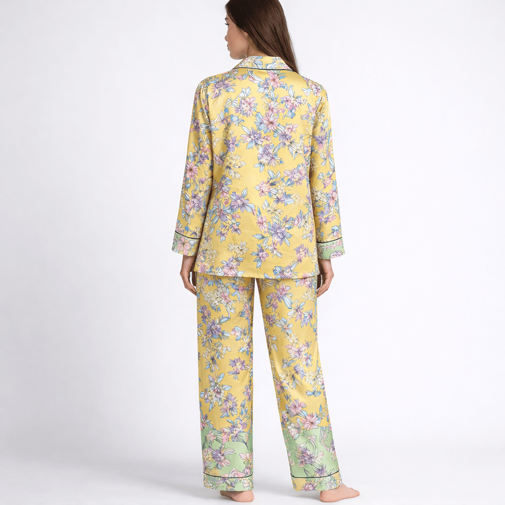 Woman wearing a yellow floral pajama set on a white background