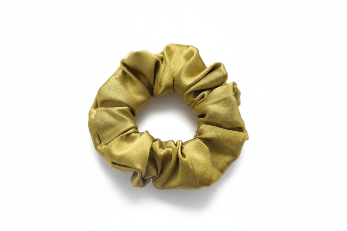 Yellow silk scrunchie on a white background